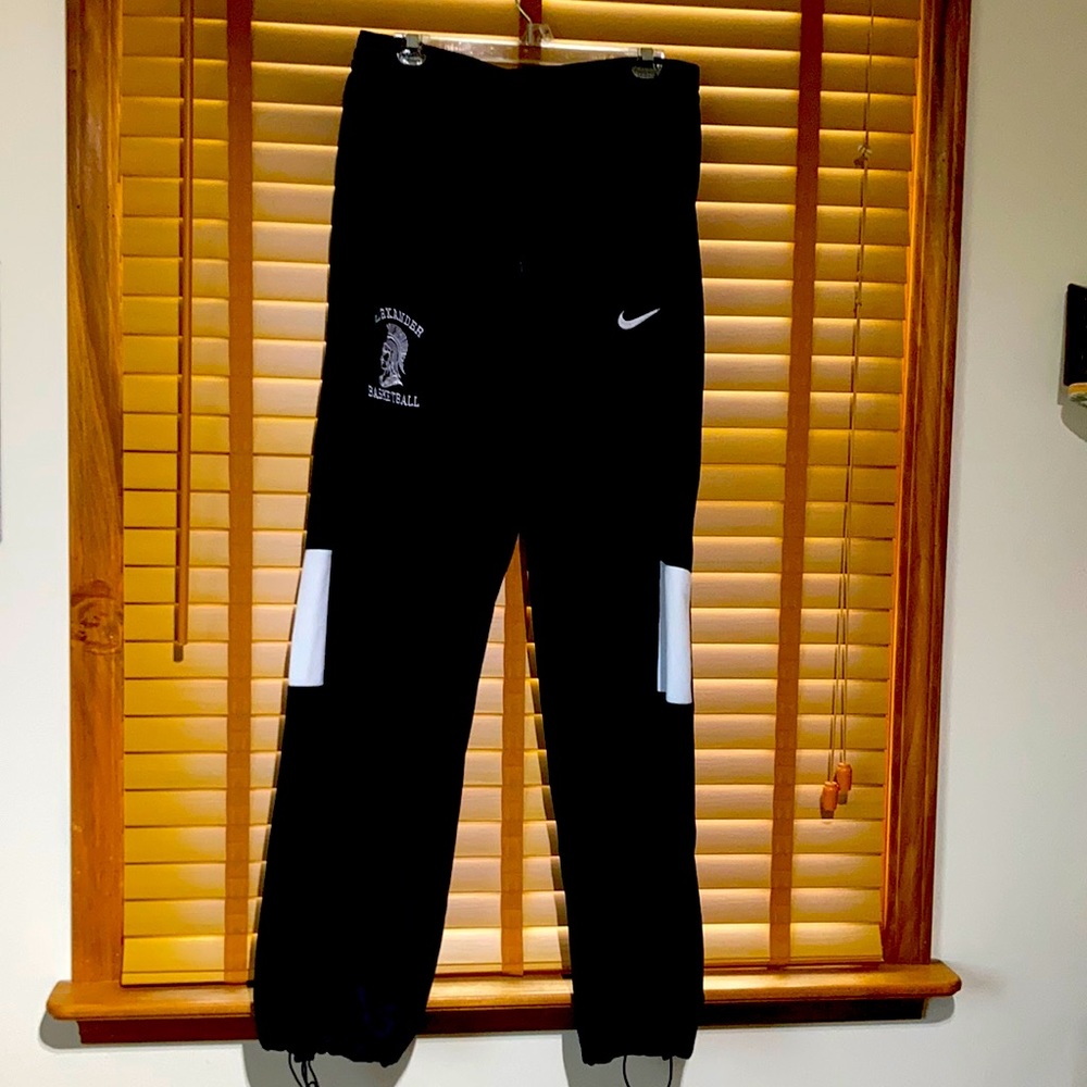 Nike XLT black athletic pants, side pockets, drawstring bottom of leg.